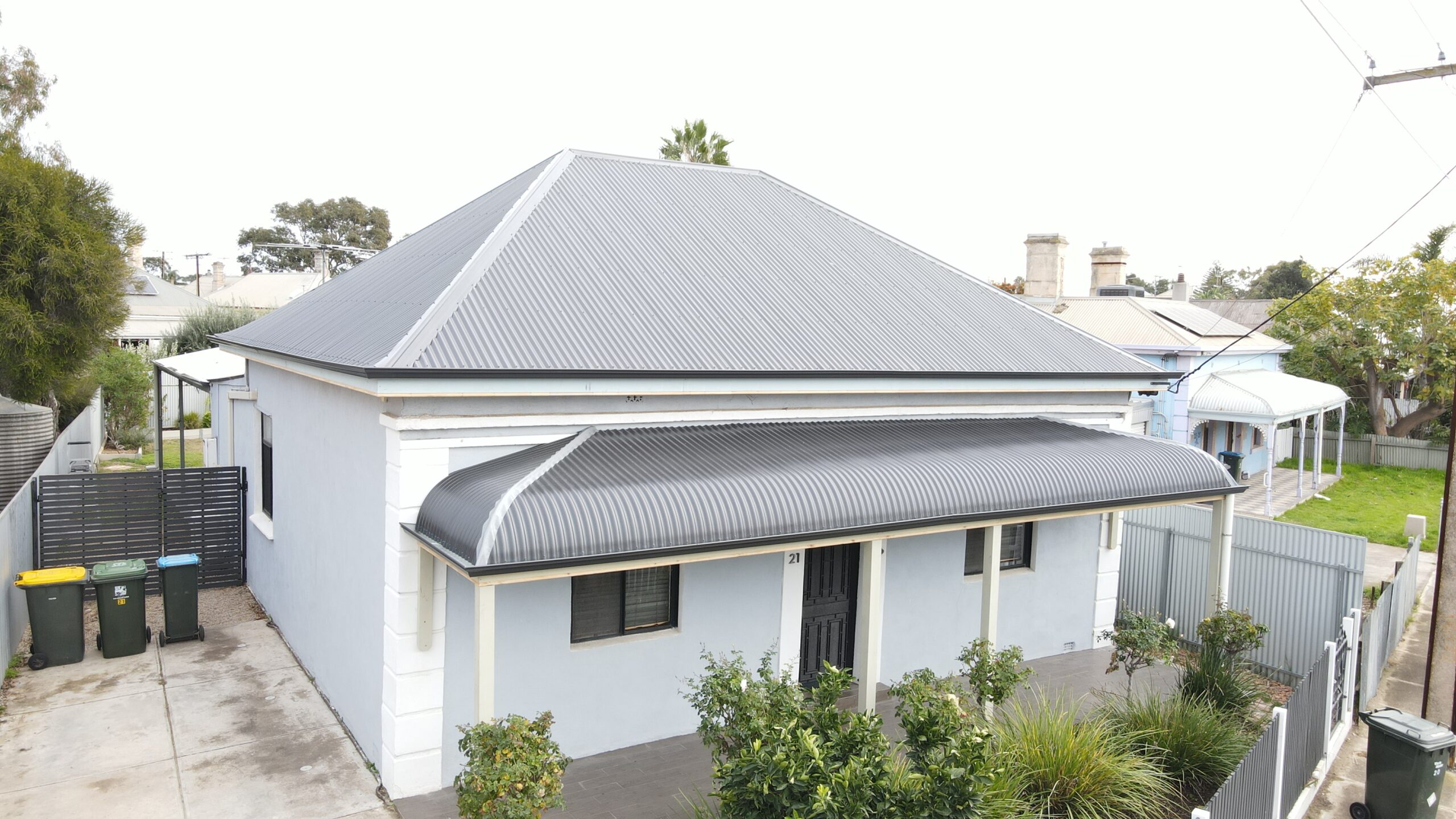 Gutter Replacement on Tiled Roof Residential roof during gutter replacement