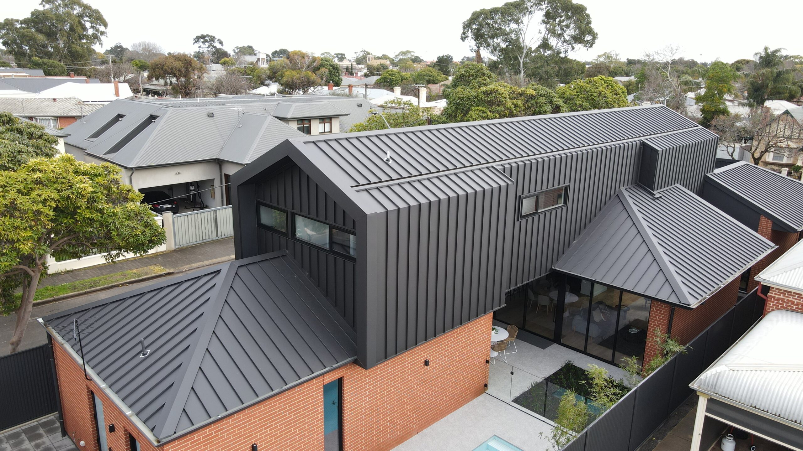 Roofs Installation in Progress Roofer working on new roofs installation