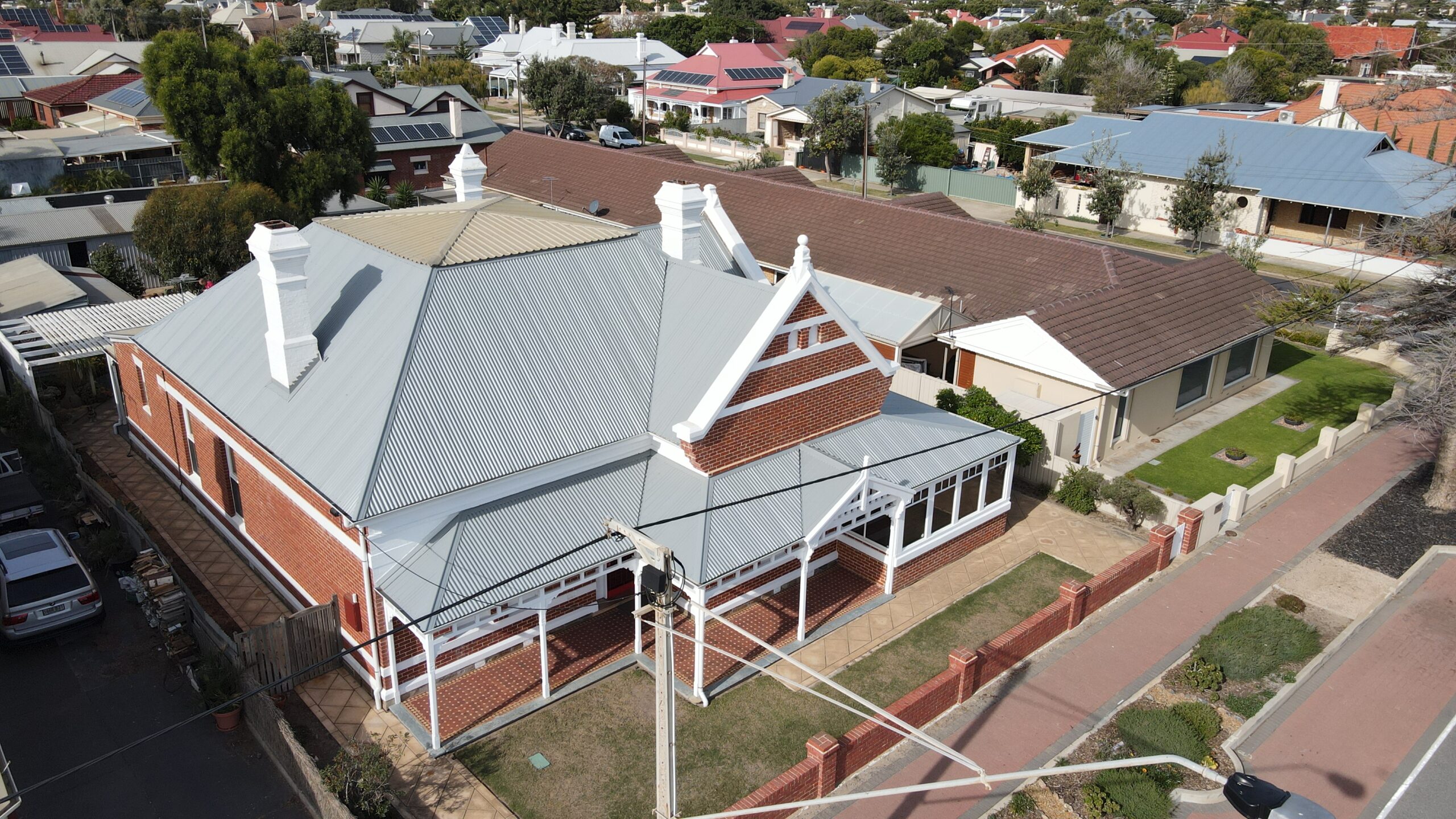 Final Roofs and Gutters Touch-Up Roofer completing final touches on roofs and gutters